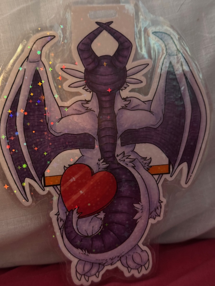 'Dangle Badge - Back' by kerijiano - September 2025
A dragon's back side as they hold on to a sign. A dragon's back side as they hold on to a sign.