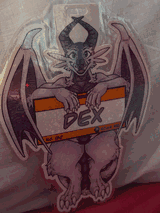 A glittery badge featuring a dragon holding on to a sign.