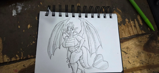 A sketch in a notebook of a dragoness walking.
