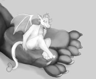 A dragon sitting on the paw of a larger dragon - with a mouse underneath the smaller dragon's left paw.